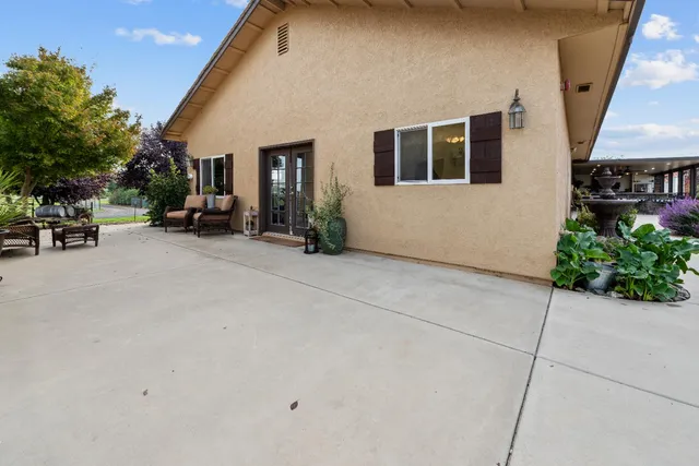 a living room with furniture a fireplace and a large window