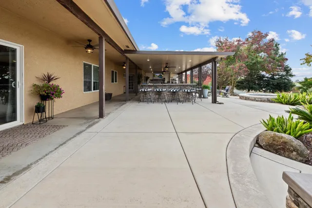 a living room with furniture a chandelier and a fireplace