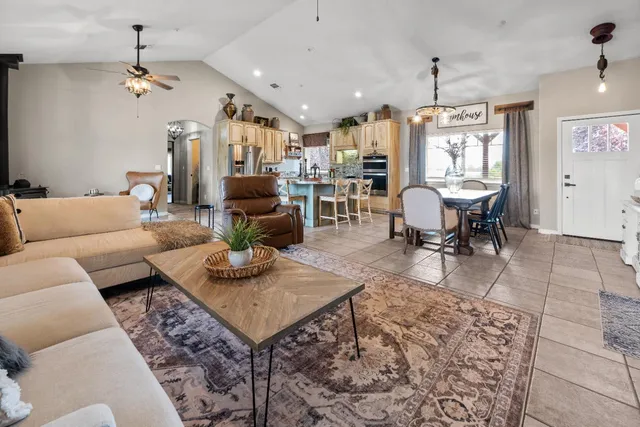 a bedroom with a bed television on desk and a window