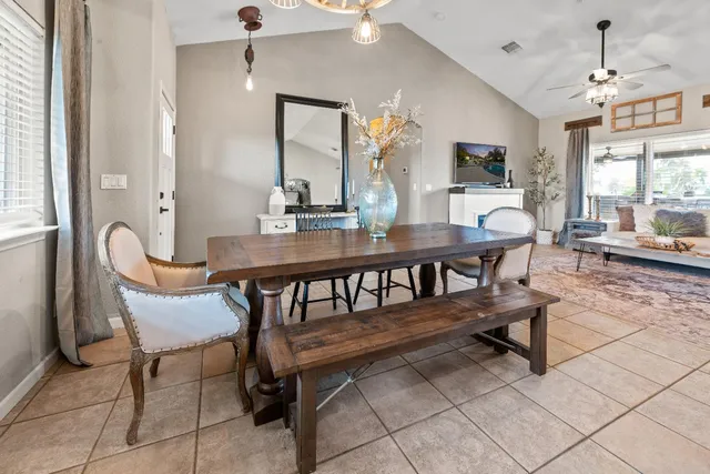 a backyard of a house with barbeque oven table and chairs