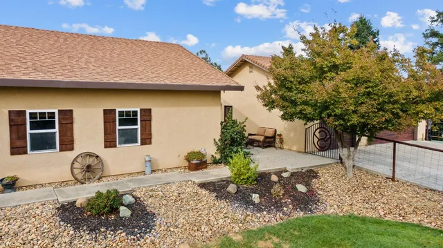 a front view of a house with a yard and trees