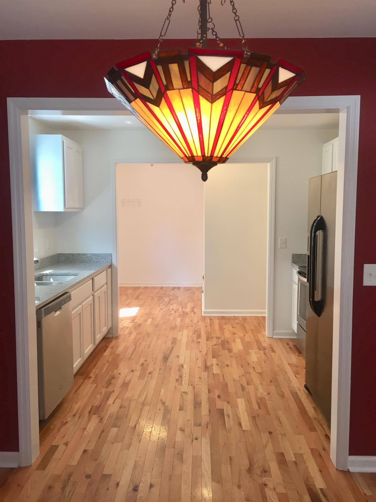 1615 Clay Street Springfield, TN 37172 - Photo 18 of 20 Gorgeous light fixture shot from the dining room into the bright kitchen!