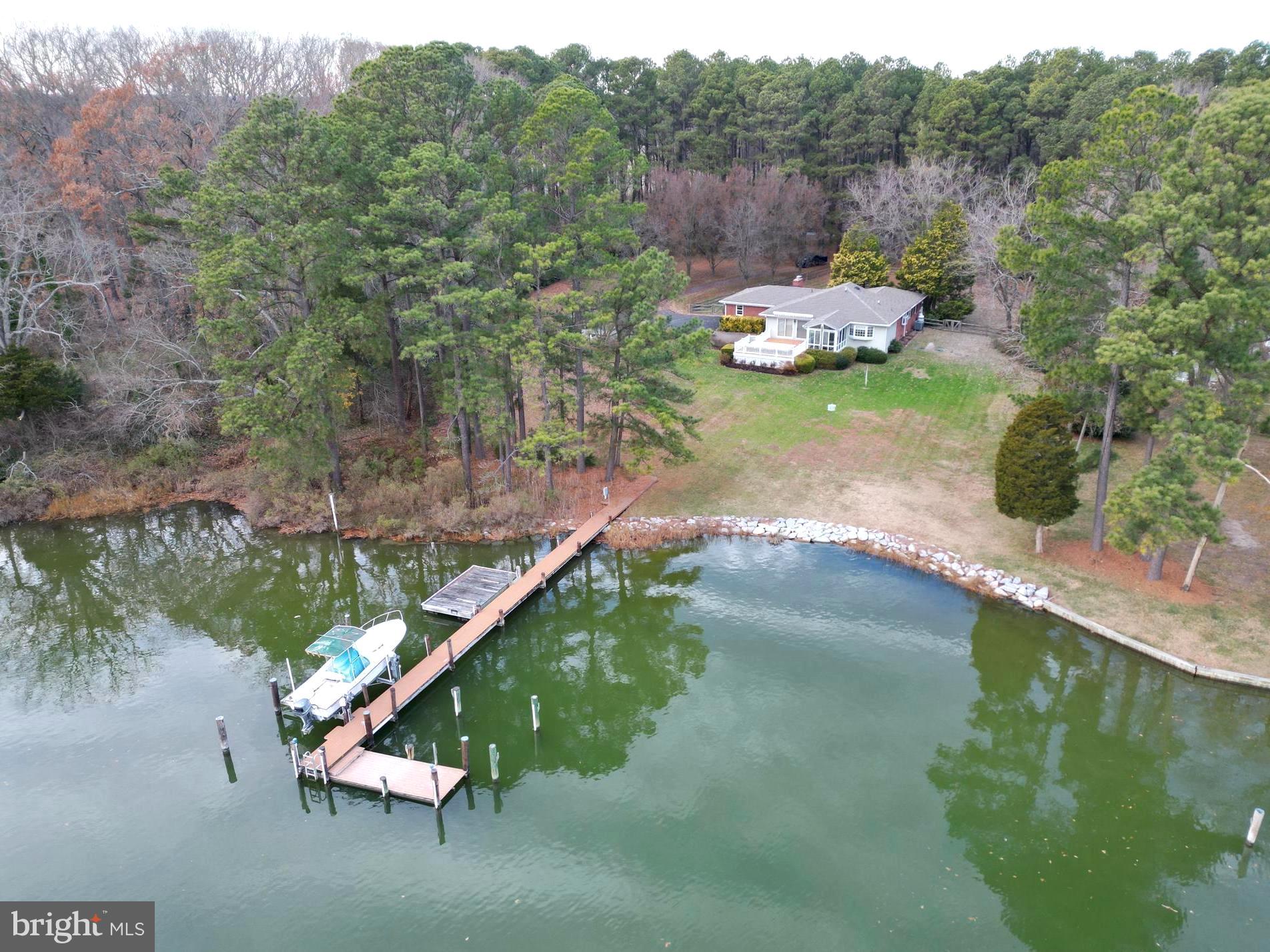 a view of a lake with a yard and a fountain