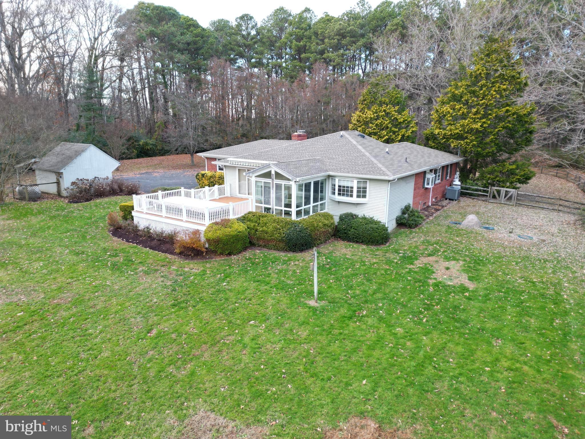 7361 Solitude Road St. Michaels, MD 21663 - Photo 12 of 23 a aerial view of a house with a yard table and chairs