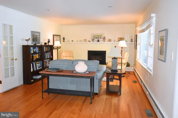 a kitchen with stainless steel appliances granite countertop a stove top oven a refrigerator a sink and dishwasher with wooden floor