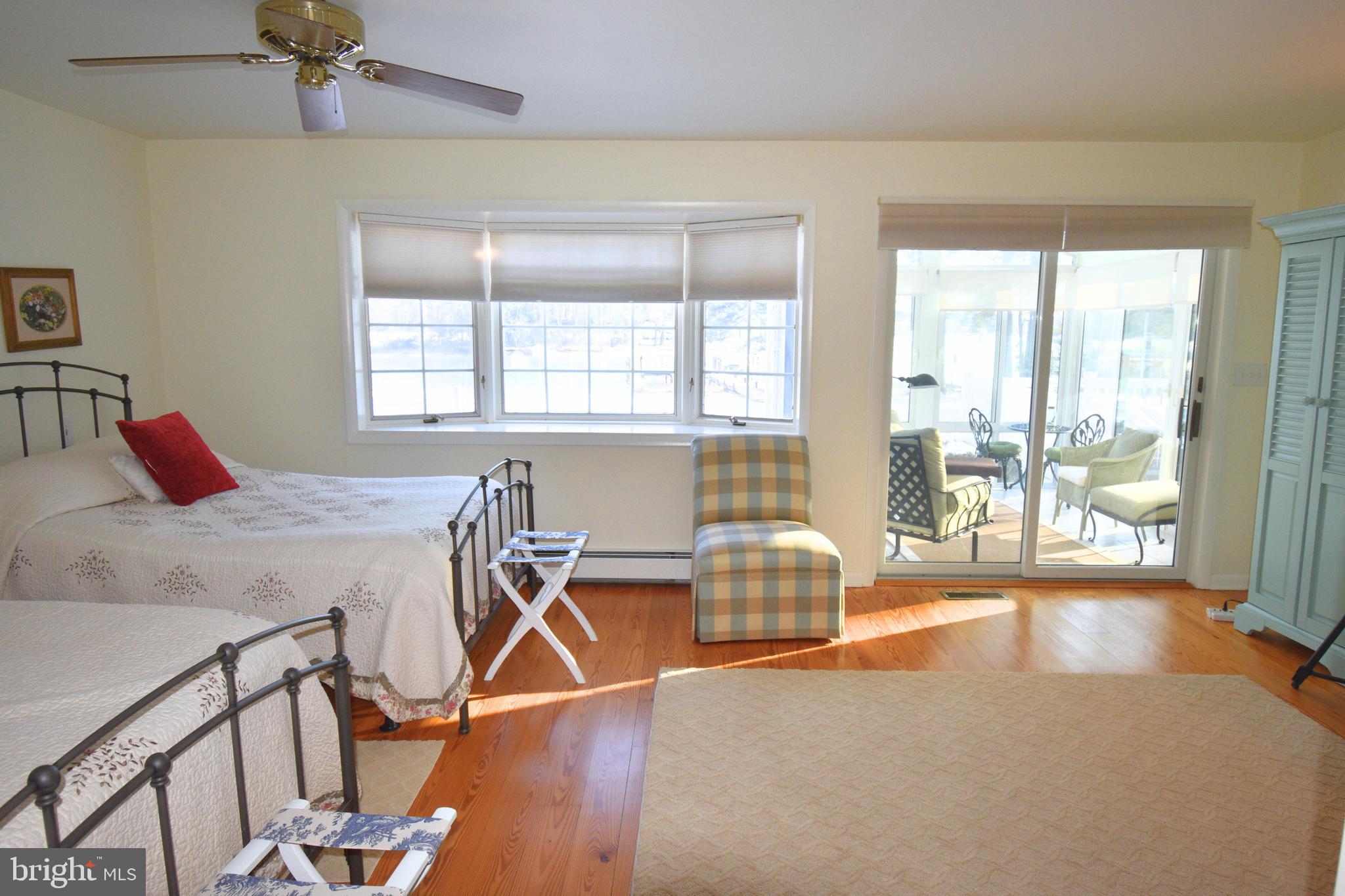 7361 Solitude Road St. Michaels, MD 21663 - Photo 17 of 23 a bedroom with a bed and a table