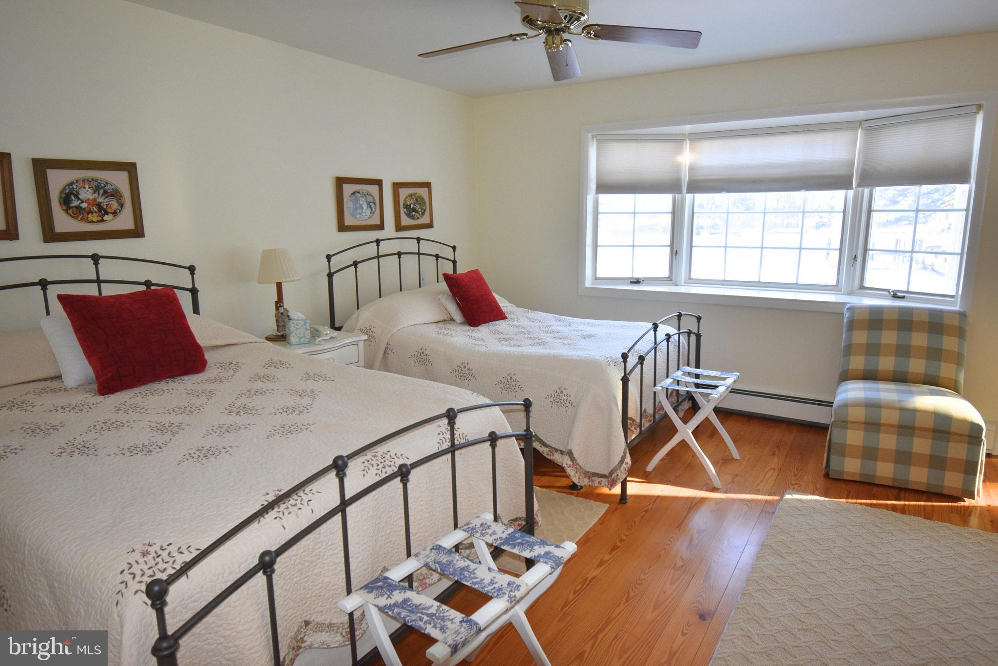 7361 Solitude Road St. Michaels, MD 21663 - Photo 20 of 23 a bedroom that has a bed and a table in it