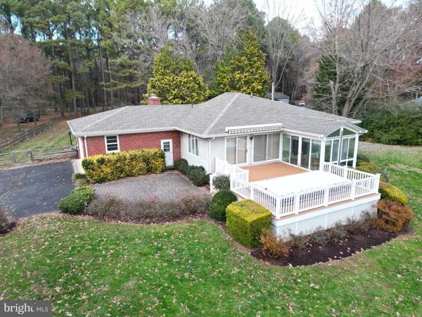a front view of a house with a yard and lake view