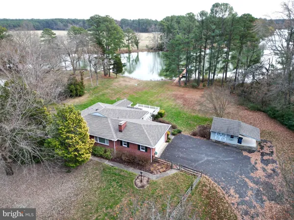 an aerial view of a house with yard
