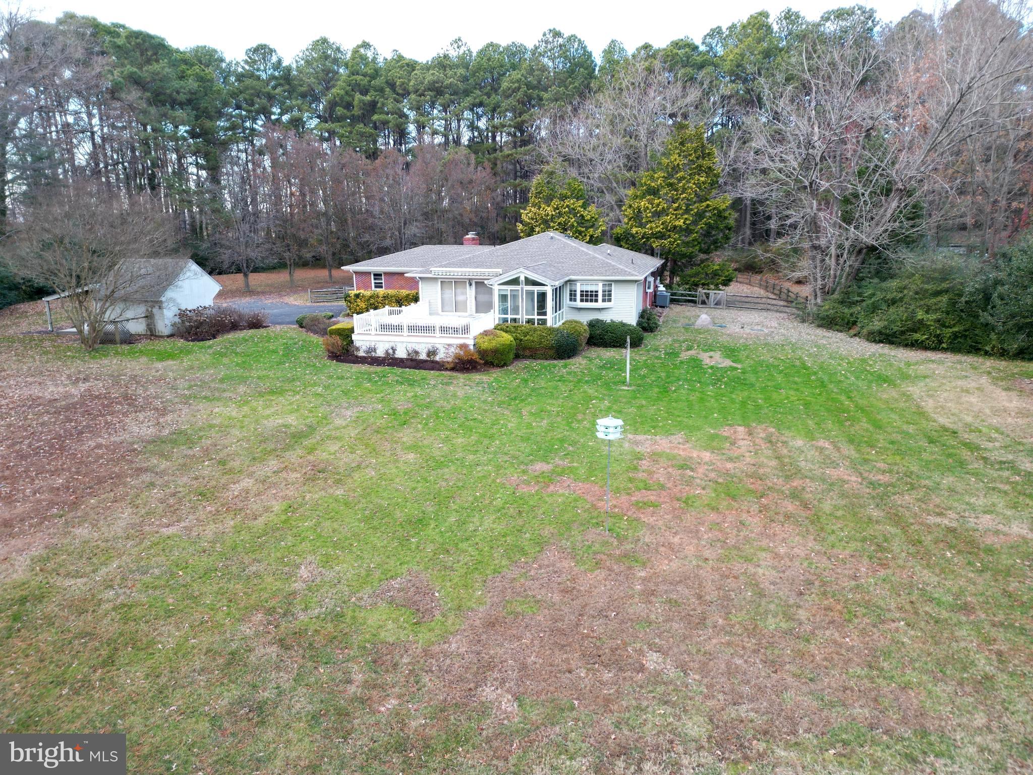 7361 Solitude Road St. Michaels, MD 21663 - Photo 5 of 23 a backyard of a house with table and chairs