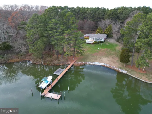 a view of a lake with a yard and mountain view