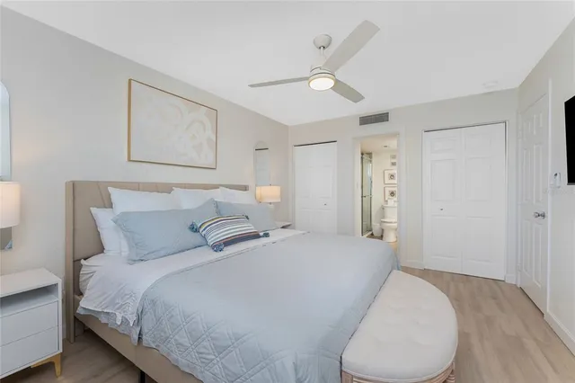 a bed room with a bed and a painting