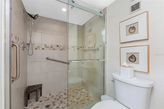 a bathroom with a toilet and a shower