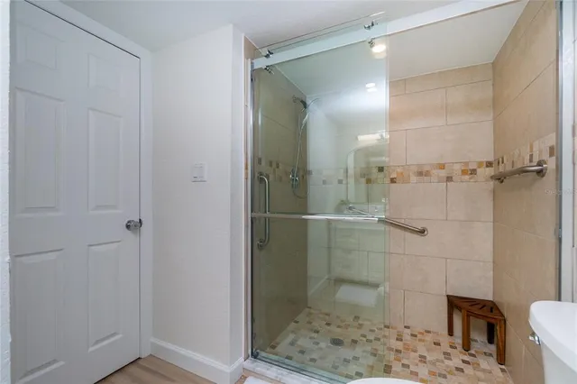 a bathroom with a glass shower door