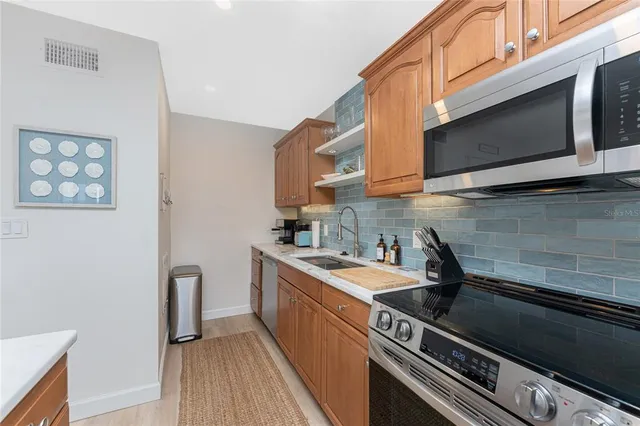a kitchen with a sink stove and microwave