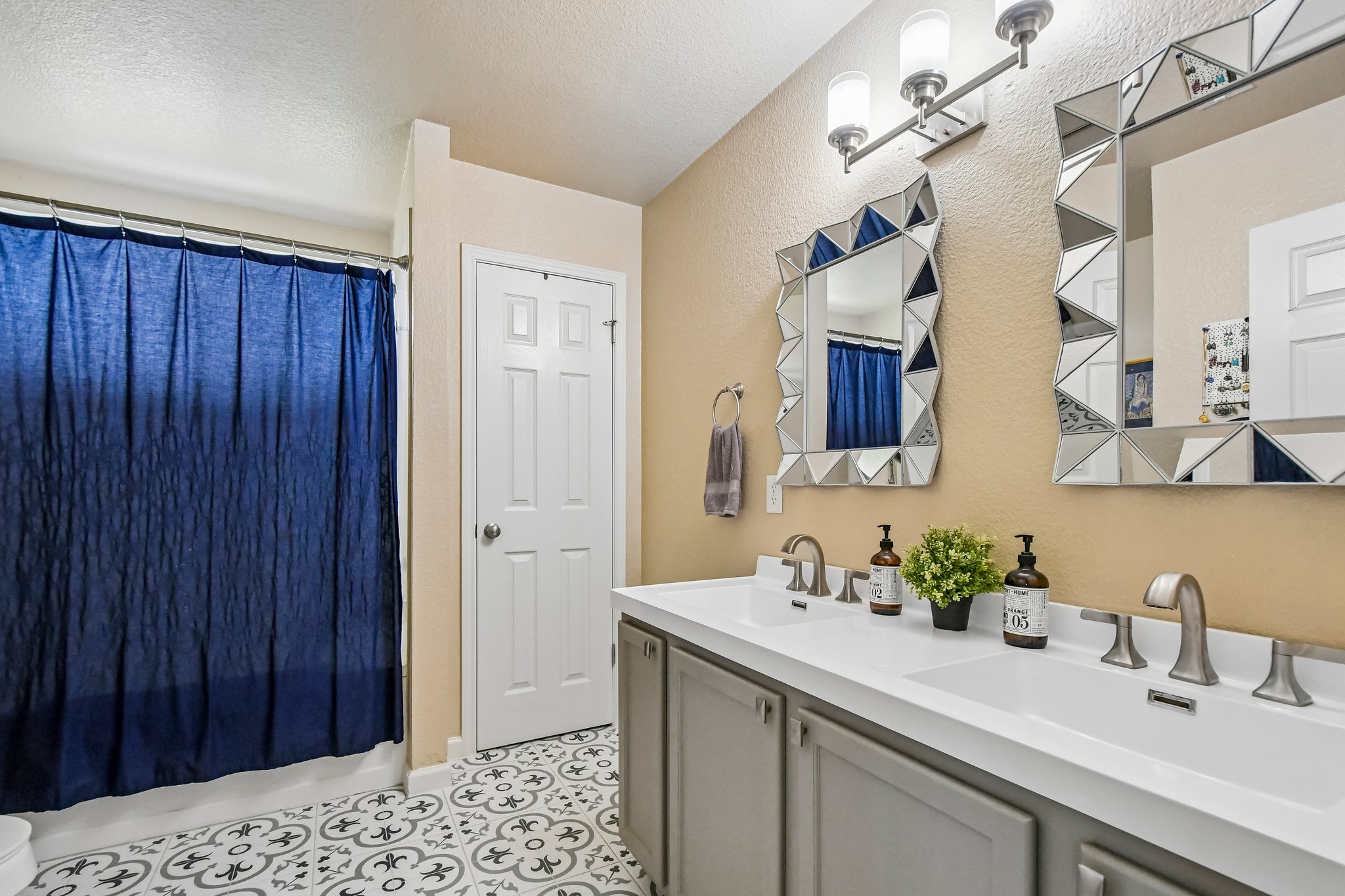 125 Mason Reed Cove Kyle, TX 78640 - Photo 28 of 39 a bathroom with a sink and a mirror