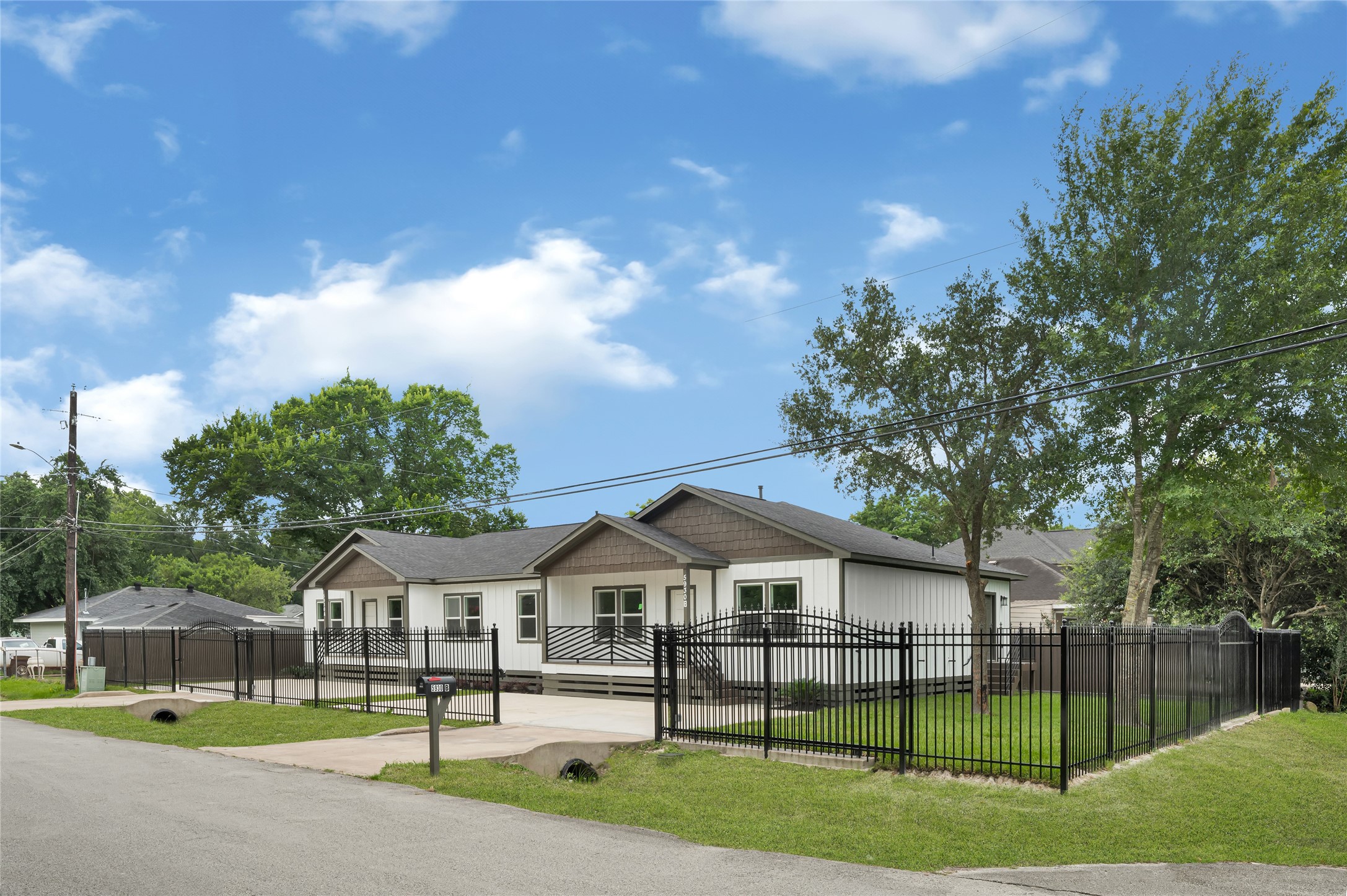 5930 Boness Road, Unit A & B Houston, TX 77396 - Photo 2 of 43 This property features a fully fenced backyard, combining elegant wrought iron fencing along the front and side perimeters with durable wood fencing along the rear and left side boundaries for added privacy.
