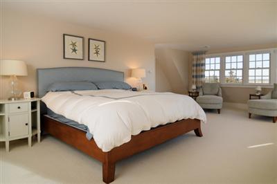 134 Salten Point Road Barnstable, MA 02630 - Photo 12 of 18 a spacious bedroom with a bed and a couch