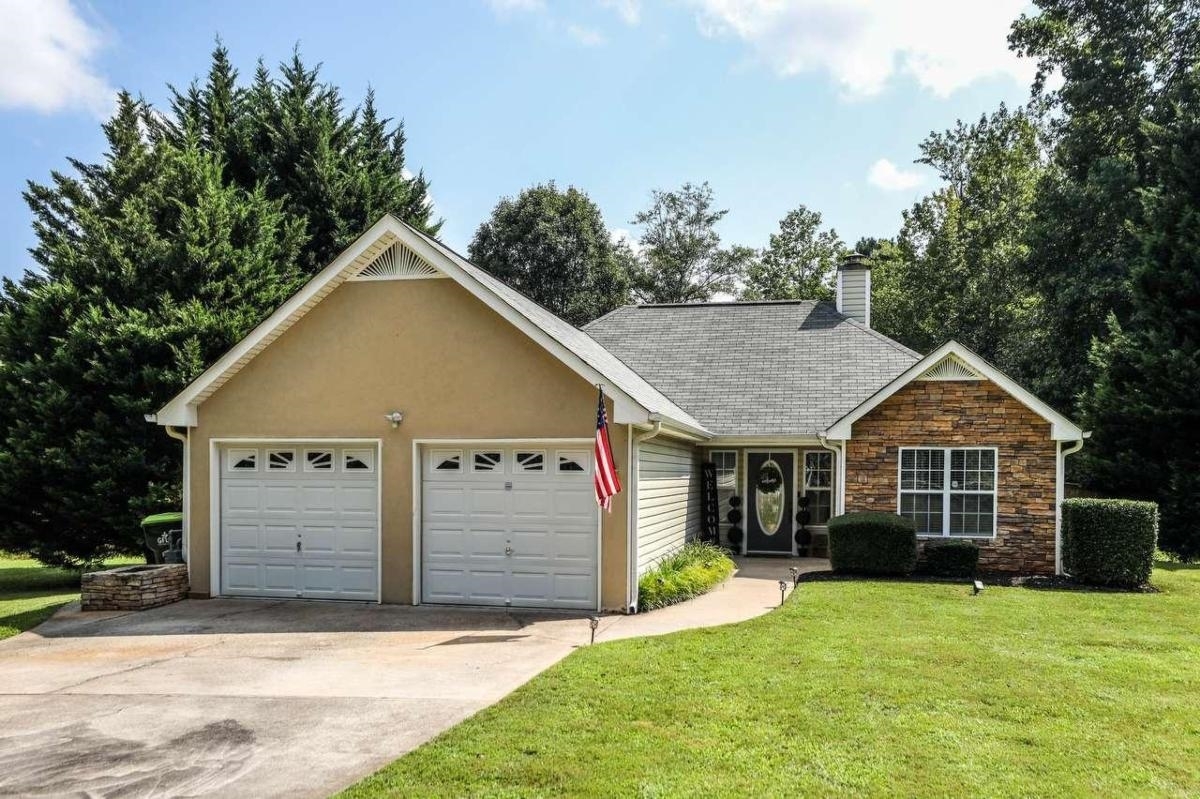 291 Lost Lake Trail, Unit 122 Villa Rica, GA 30180 - Photo 1 of 1 a view of a house with a yard plants and large tree