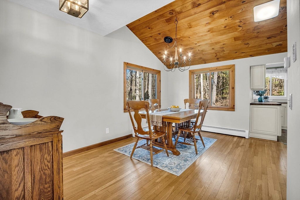 337 Hubbardston Road Princeton, MA 01541 - Photo 10 of 42 a dining room with furniture a chandelier and wooden floor