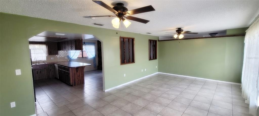 406 Wright Street Inverness, FL 34452 - Photo 14 of 38 a view of a kitchen with a sink and a ceiling fan