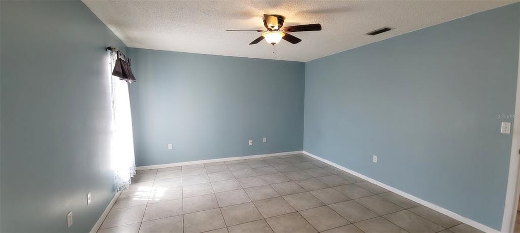 406 Wright Street Inverness, FL 34452 - Photo 23 of 38 wooden floor in an empty room with a window
