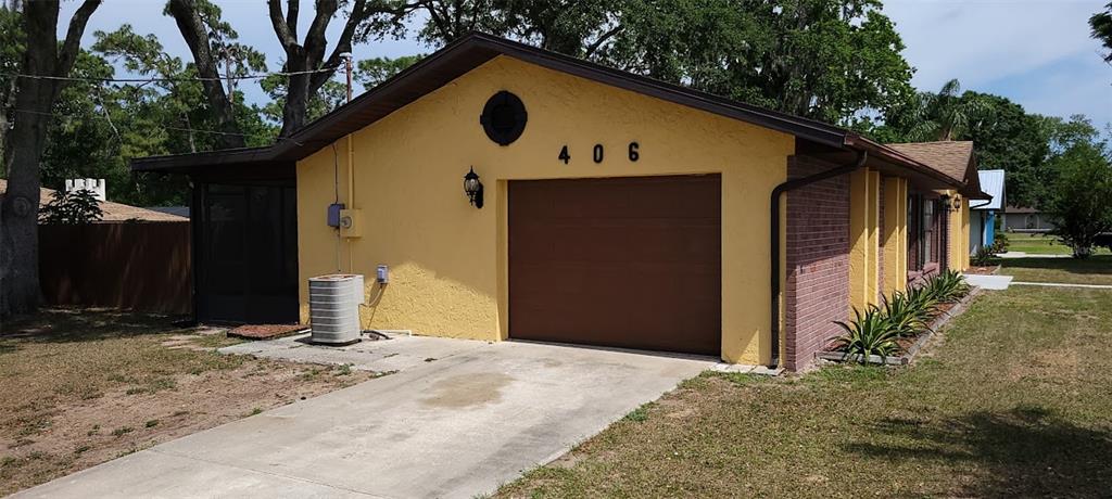 406 Wright Street Inverness, FL 34452 - Photo 3 of 38 a front view of a house with a yard