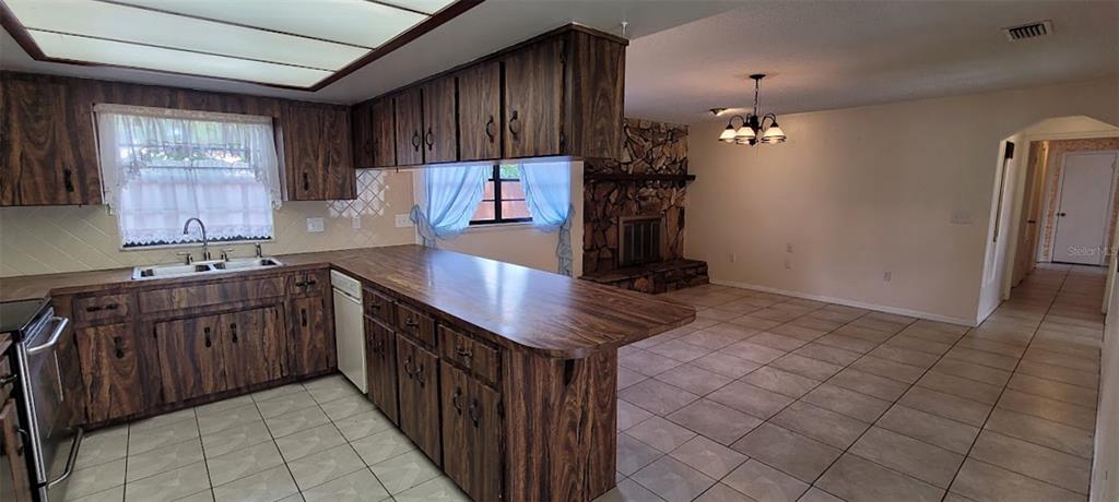 406 Wright Street Inverness, FL 34452 - Photo 10 of 38 a kitchen with stainless steel appliances granite countertop a sink stove and cabinets