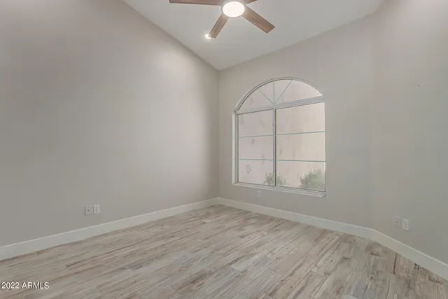 a large hall with kitchen island furniture a chandelier and a view of living room