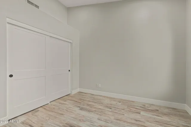 a kitchen with a sink dishwasher a dining table and chairs with wooden floor