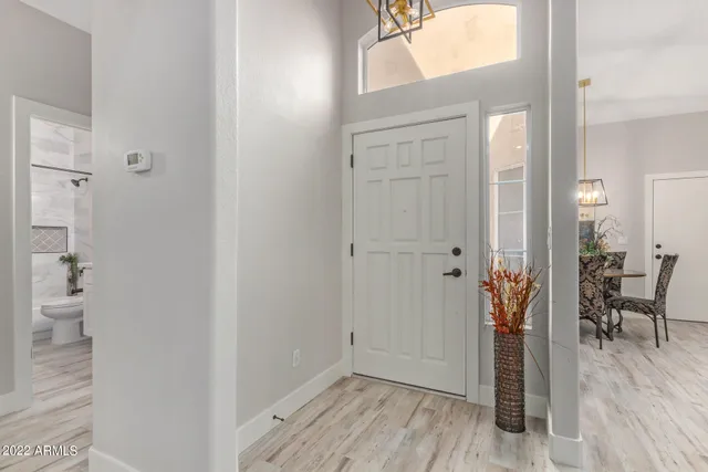 a living room with furniture and a painting on the wall