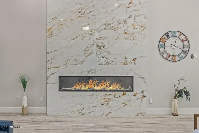 a kitchen with a sink stove and white cabinets with wooden floor