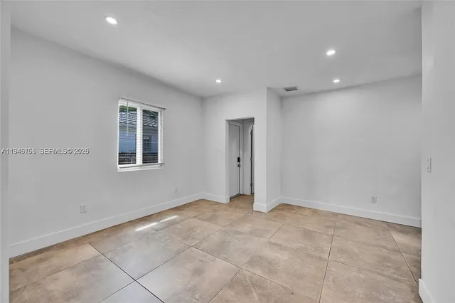 a view of an empty room with a window