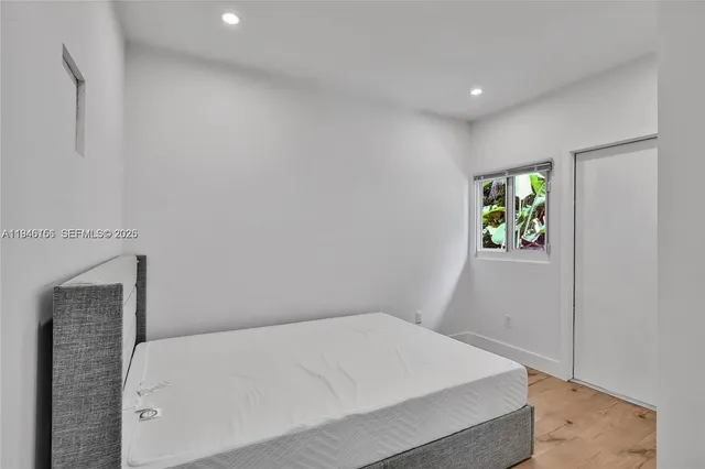 a bedroom with a bed and a window