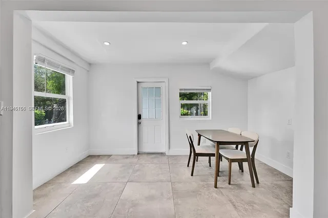 a view of a room that has a window and a table in it