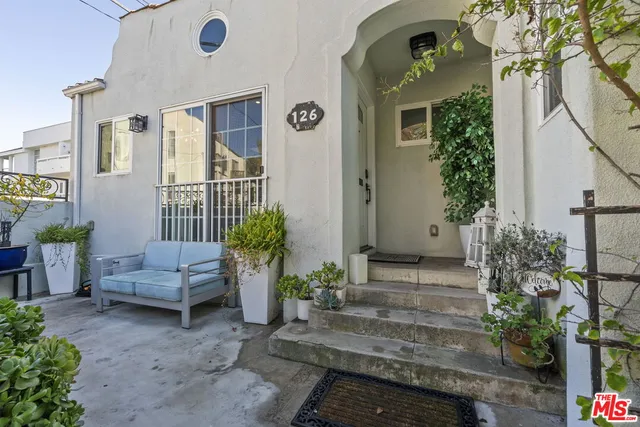 a living room with furniture and flowers