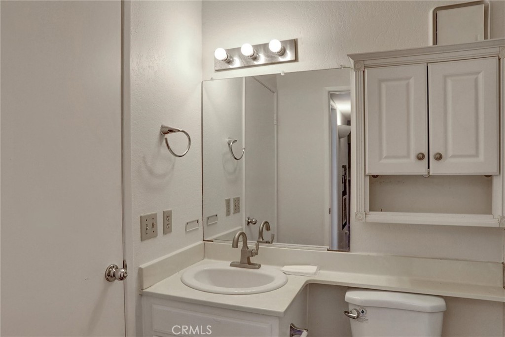 21309 Eucalyptus Way, Unit 203 Newhall, CA 91321 - Photo 8 of 20 a bathroom with a sink and a mirror