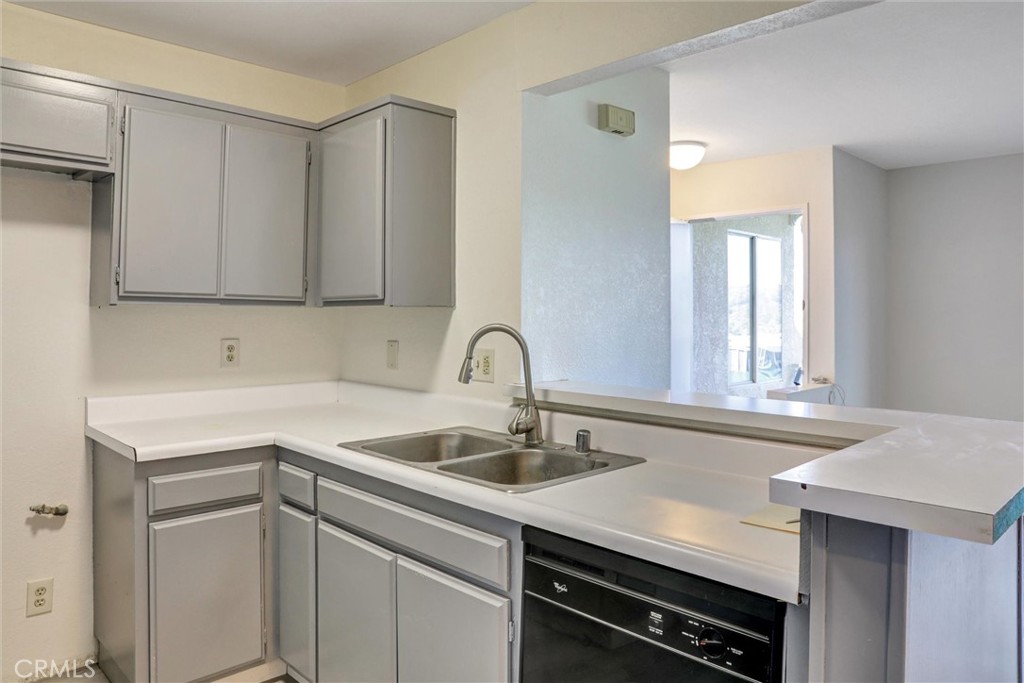 21309 Eucalyptus Way, Unit 203 Newhall, CA 91321 - Photo 10 of 20 a kitchen with a sink cabinets and appliances