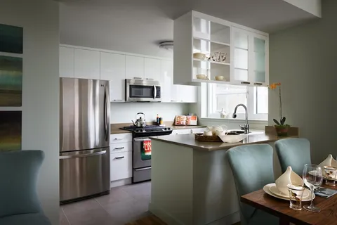 a kitchen with stainless steel appliances a refrigerator stove and sink