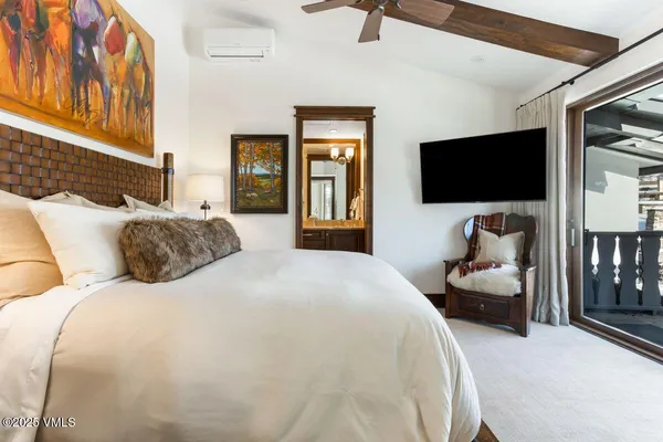 a bedroom with a bed and a mirror