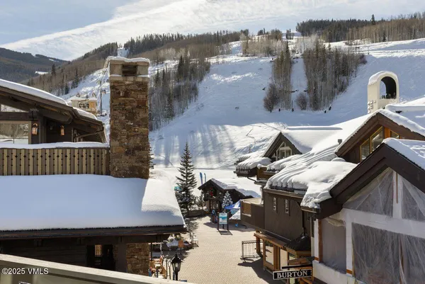 a view of a chairs and table in the balcony