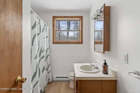a bathroom with a sink a mirror and a window