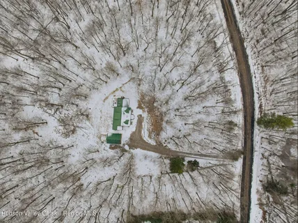a view of a house with a yard covered in snow