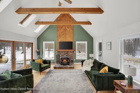 a living room with furniture a fireplace and a flat screen tv