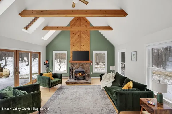 a living room with furniture a fireplace and a flat screen tv