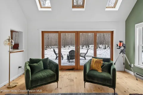 a living room with furniture and a floor to ceiling window