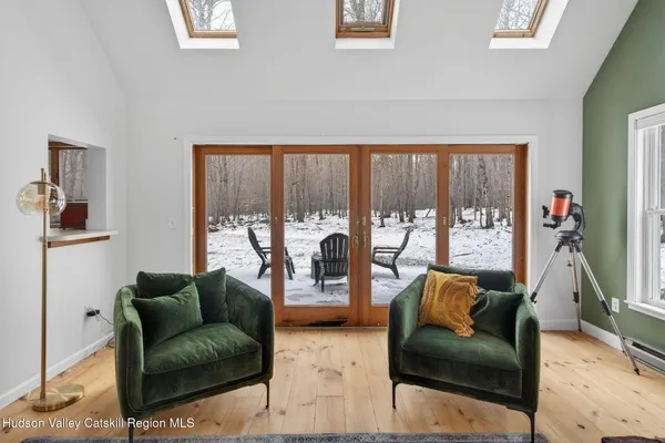 a living room with furniture and a floor to ceiling window