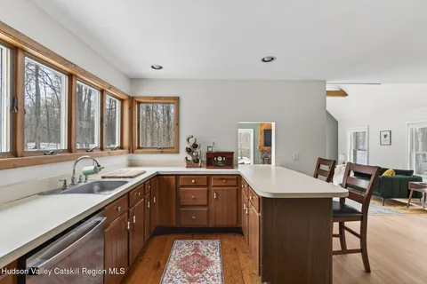 a kitchen with a sink dining table and chairs
