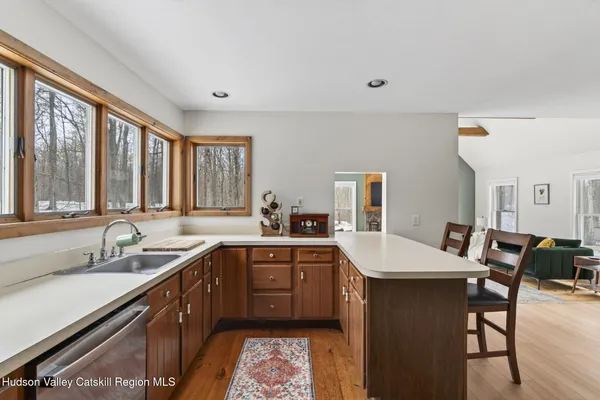 a kitchen with a sink dining table and chairs