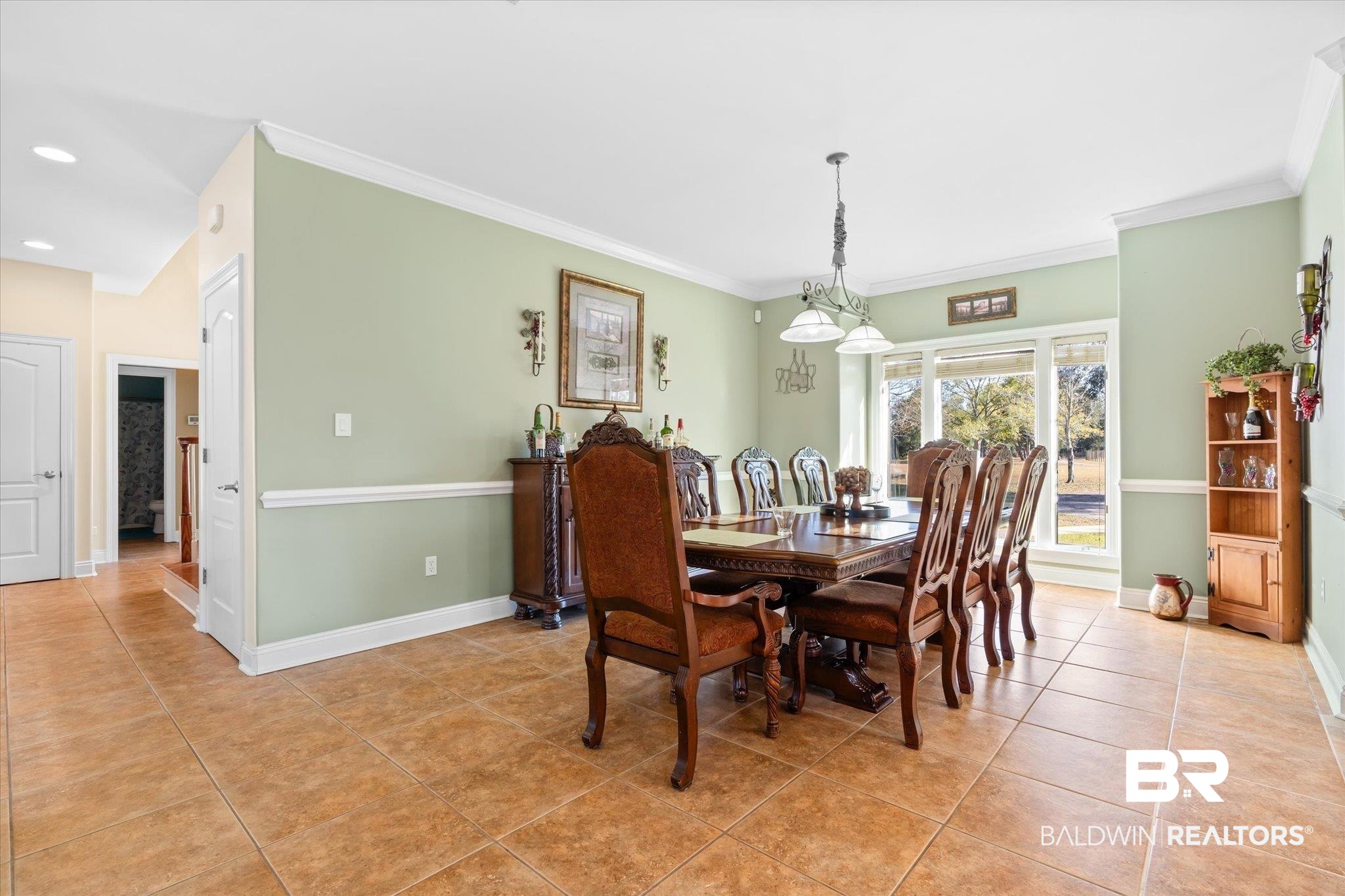 15635 County Road 83 Elberta, AL 36530 - Photo 8 of 54 Dining area with light tile patterned flooring, ornamental molding, and an inviting chandelier